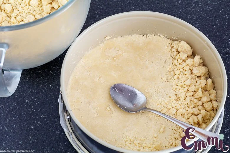 Streuselboden festdruecken für den Rhabarberkuchen - www.emmikochteinfach.de